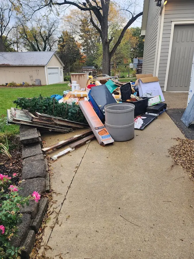 Dumpster being loaded with debris for Estate Cleanout Dumpster Rental in Niagara Falls